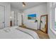 Bright bedroom with a dresser, large windows, and ensuite bathroom at 105 6Th S St, Bradenton Beach, FL 34217