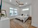 Cozy bedroom with large windows, wood floors and a ceiling fan at 105 6Th S St, Bradenton Beach, FL 34217