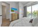 Bedroom with balcony access, dresser, and large bed at 105 6Th S St, Bradenton Beach, FL 34217