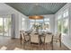 Bright dining room with an oval table and six chairs, features a unique ceiling design and large windows at 105 6Th S St, Bradenton Beach, FL 34217