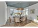 Bright dining room with an oval table and six chairs, unique ceiling design and large windows at 105 6Th S St, Bradenton Beach, FL 34217