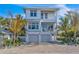 Two-story home with two-car garage and tropical landscaping at 105 6Th S St, Bradenton Beach, FL 34217