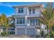 Two-story home with two-car garage and tropical landscaping at 105 6Th S St, Bradenton Beach, FL 34217