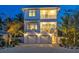 Two-story home with a modern design, two-car garage, and palm trees at 105 6Th S St, Bradenton Beach, FL 34217
