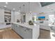 Open concept kitchen boasting a marble island, modern appliances, and stylish lighting at 105 6Th S St, Bradenton Beach, FL 34217