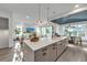 Modern kitchen with a large island, white cabinets, and a unique wooden hood at 105 6Th S St, Bradenton Beach, FL 34217