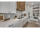 Sleek kitchen with white cabinetry, marble countertops, and herringbone backsplash at 105 6Th S St, Bradenton Beach, FL 34217