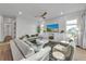 Spacious living room with white sofas, a large TV, and a ceiling fan at 105 6Th S St, Bradenton Beach, FL 34217