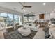 Open concept living room with white sofas and access to a balcony at 105 6Th S St, Bradenton Beach, FL 34217