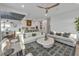 Open living space with white sofas and a view into the kitchen and dining area at 105 6Th S St, Bradenton Beach, FL 34217