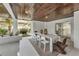 Covered patio with dining table and chairs, adjacent to grilling area at 105 6Th S St, Bradenton Beach, FL 34217
