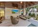 Relaxing outdoor lounge area with comfortable seating and large TV at 105 6Th S St, Bradenton Beach, FL 34217