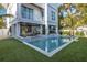 Stunning pool area with a modern design and lush landscaping at 105 6Th S St, Bradenton Beach, FL 34217