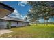 Spacious backyard with grassy lawn, providing ample outdoor space at 1051 Truman St, Nokomis, FL 34275