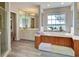 Bathroom with a large soaking tub, walk-in shower, and double vanity at 1051 Truman St, Nokomis, FL 34275