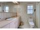 Bathroom with pink vanity and updated toilet at 1051 Truman St, Nokomis, FL 34275