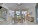 Bright dining area with glass table, wicker buffet, and view to backyard at 1051 Truman St, Nokomis, FL 34275