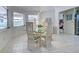 Bright dining area with glass table, wicker buffet, and view to backyard at 1051 Truman St, Nokomis, FL 34275