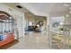 Bright dining room with glass table and seating, open to living area at 1051 Truman St, Nokomis, FL 34275