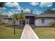 Front entry of single story home with walkway and landscaping at 1051 Truman St, Nokomis, FL 34275