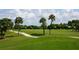 Golf course with palm trees and a cart on the fairway at 1051 Truman St, Nokomis, FL 34275