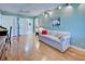Cozy guest room features hardwood floors and a comfortable sofa at 1051 Truman St, Nokomis, FL 34275