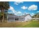 House back view with pool and screened enclosure at 1051 Truman St, Nokomis, FL 34275