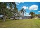 House exterior with lush landscaping and canal view at 1051 Truman St, Nokomis, FL 34275