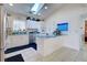 Bright kitchen with white cabinets, teal countertops, and stainless steel appliances at 1051 Truman St, Nokomis, FL 34275