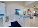 Bright kitchen with white cabinets, teal countertops, and stainless steel appliances at 1051 Truman St, Nokomis, FL 34275