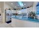 Bright kitchen with white cabinets, teal countertops, and stainless steel appliances at 1051 Truman St, Nokomis, FL 34275