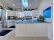 Bright kitchen with white cabinets, teal countertops, and stainless steel appliances at 1051 Truman St, Nokomis, FL 34275