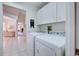Clean laundry room with washer, dryer and cabinets at 1051 Truman St, Nokomis, FL 34275