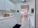 Functional laundry room with cabinets and sink at 1051 Truman St, Nokomis, FL 34275