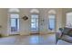 Bright living room with tile floors, arched windows, and comfortable seating at 1051 Truman St, Nokomis, FL 34275