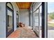 Covered porch with brick flooring, terracotta pots, and access to the house at 1051 Truman St, Nokomis, FL 34275