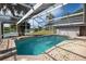 Sparkling pool with screened enclosure and lake view at 1051 Truman St, Nokomis, FL 34275