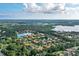 Aerial view of houses and a lake in a lush green community at 11432 Savannah Lakes Dr, Parrish, FL 34219