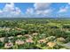 Aerial view of a neighborhood with houses near a golf course at 11432 Savannah Lakes Dr, Parrish, FL 34219