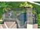 Aerial view of home showing screened pool and lush landscaping at 11432 Savannah Lakes Dr, Parrish, FL 34219