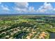 Aerial view of a neighborhood with golf course and water features at 11432 Savannah Lakes Dr, Parrish, FL 34219