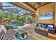 Relaxing covered patio overlooking the pool and waterfall feature at 11432 Savannah Lakes Dr, Parrish, FL 34219