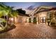 Home exterior at night with lights illuminating the driveway at 11432 Savannah Lakes Dr, Parrish, FL 34219