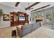 Living area showcasing a gray sectional sofa, an elegant entertainment center, and a fireplace at 11432 Savannah Lakes Dr, Parrish, FL 34219