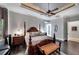 Luxurious main bedroom with a king-size bed, dark hardwood floors and beautiful wood furniture at 11432 Savannah Lakes Dr, Parrish, FL 34219