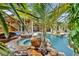Tropical pool oasis with waterfall and spa features at 11432 Savannah Lakes Dr, Parrish, FL 34219