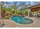 Resort-style pool with a waterfall and a covered patio at 11432 Savannah Lakes Dr, Parrish, FL 34219