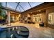 Expansive covered patio with pool and outdoor kitchen at 11432 Savannah Lakes Dr, Parrish, FL 34219