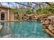 Enclosed pool and spa with waterfall feature at 11432 Savannah Lakes Dr, Parrish, FL 34219