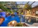 Enclosed pool and firepit area with lush landscaping at 11432 Savannah Lakes Dr, Parrish, FL 34219